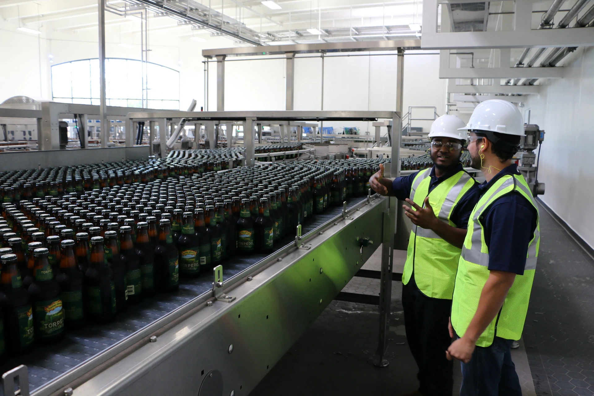 cta-banner-image Workers discuss assembly line